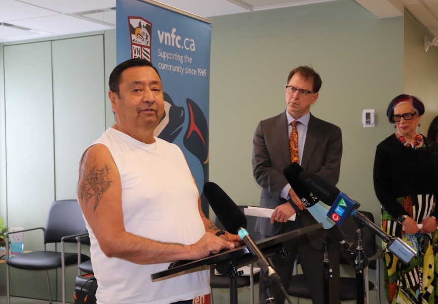 Melvin Jones speaks about his treatment at the Victoria Native Friendship Centre health facility, as Minister of Health Adrian Dix and Leah Hollins, board chair of Island Health stand listening. (Denise Titian photos) 