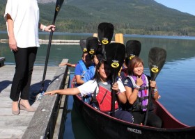 Princess Sophie poses with the Ditidaht Paddle Club and the canoe named Princess