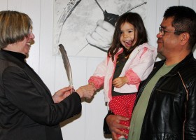Heidi Swan gifts a eagle feather to the Lt-Gov. with dad James Swan looking on.