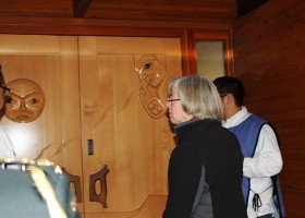 Lieutenant Governor of British Columbia admires the front doors of the Tseshaht Administration Building