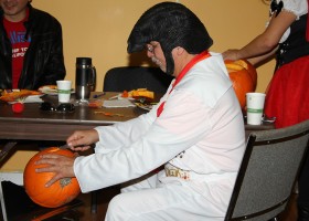 Elvis carves a pumpkin