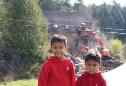 Hesquiaht boys Kalanis, 6, and Maya (Niumaia), 4, witnessed the excavator tear down the bad place with mean teachers on Meares Island. The boys went to the Oct. 9 healing event in support of their grandmother Marilyn Lucas and their late grandfather Pat Charleson Jr. who both attended residential school.