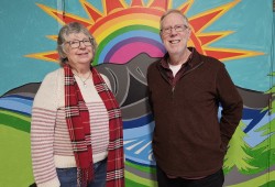 Reverend Ed Lewis and Mary Heatherington, the Alberni Valley United Church worship assistant, stand before the new mural. (Denise Titian photo)
