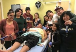 Keith Atleo recovers in hospital, surrounded by his family. (Keith Atleo photo)