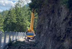 A temporary wall and nets are in place along Highway 4 to ensure loose rocks and trees stay off of the single lane being used by traffic. (BC Ministry of Transportation and Infrastructure photo)