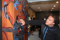 Patrick Amos speaks about an illustration he painted on a door in the coast guard station.
