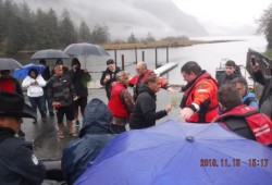 Fisheries and Oceans Canada officers are brushed by members of the Mowachaht/Muchalaht First Nation after transporting the orca.