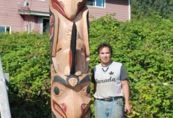 Carver Sanford Williams stands with the totem pole after its completion in Yuquot. (Submitted photo)