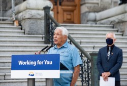 Huu-ay-aht Chief Councillor Robert Dennis speaks at the B.C. legislature with MLA Scott Fraser at road improvement announcement in 2020. (Province of BC photo)