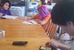 Irene Joseph’s children do school work at their grandparents table in Kyuquot. (Irene Joseph photo)