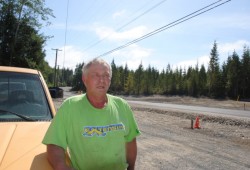 Martie Robertson stands by a newly paved road in Anacla, next to an 11-lot subdivision his company completed.  