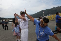 Commander Sam Patrick dances with Tseshaht members after being welcomed ashore by the First Nation.