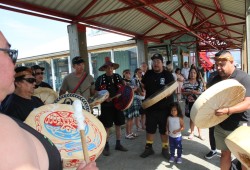 Tseshaht members sing and drum at Port Alberni's Harbour Quay.