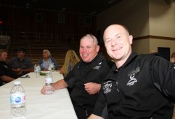 Const. Mitch Gordon (left) of the Nanaimo RCMP and Const. Mark Hendren of the Saanich Police Department await their meal at the Tour de Rock dinner. 