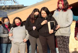 Mother Iris Clarke holds pictures of her son, as her family gathers at the steps of the Port Alberni Friendship Center, after the body of 18-year-old Clifton Johnson was found at the location on March 27, 2021.  (Denise Titian photo)