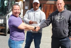 Left to right: Carolina Tatoosh shakes hands with Green Coast Dispensary owners Rudy Watts and Dwight Dockendorf outside the Hupacasath First Nation’s administrative office. The business made a donation to a youth group Tatoosh is involved with. (James Paracy photo)