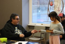 Jesse Maquinna presents a gift to NTC Vice President Les Doiron.