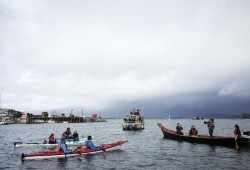 Boaters and kayakers gathered in the Tofino harbour to protest against fish farms.