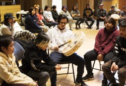 Andrew Savey-Johnson (centre) drums during the NTC Northern Region Youth Gathering at the House of Unity, in Tsa'xana, near Gold River, on March 29, 2022.