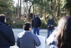 Tla-o-qui-aht First Nation members gathered in front of the nation's main office near the Best Western Plus Tin Wis Resort in Tofino to protest recent housing evictions to council members, on March 31, 2022.