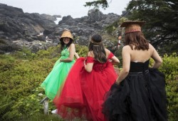 Roshelle Bob looks back to her friends as they line up to have their photo taken near the lighthouse in Ucluelet on their graduation day.