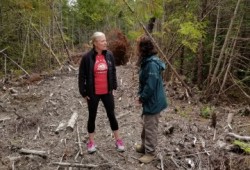 Catherine McKenna, federal minister of Environment and Climate Change, speaks with kweesh-kweesh-ata-aqsa, Tammy Dorward, First Nation liaison with Pacific Rim National Park Reserve at the site of ʔapsčiik t̓ašii.(Parks Canada)