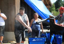 Melvin Good Jr. and Sharon Charlie step out of the shed for some air as they sand the Tseshaht canoe. The two travelled from Nanaimo and Ahousaht respectively to help prepare the canoe for the water.      