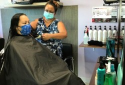 Kelita Sieber cuts Jennifer Rivers' hair at Sieber's new salon, Sacred Cedars Salon, at Nitinaht Lake. (Submitted photo)