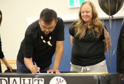 Ditidaht Chief Councillor Brian Tate signs an agreement with Stephanie Atleo, president of the First Nation Education Authority, that gives the Ditidaht educational jurisdiction on its land.