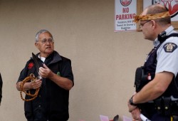 Joseph Tom, senior culture worker at the Nuu-chah-nulth Tribal Councils’ Quu'asa program, talks about the significance of the eagle feather in Nuu-chah-nulth culture as Port Alberni RCMP CST. Pete Batt listens during a ceremony on June 5.