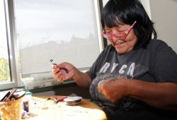 Roberta Touchie works with beads at Our Place, an activity the Yuułuʔiłʔatḥ First Nation member regularly engages in at the site.