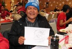 John Paul displays a drawing at the event.