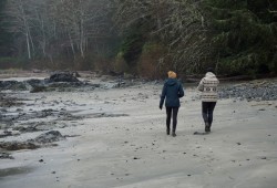Inspired by Tla-o-qui-aht’s allies program, a one-per-cent fee would help mitigate the impacts of increased visitation to Bamfield. Pictured are visitors walk along Brady's Beach on the west side of Bamfield. (Karly Blats photo)