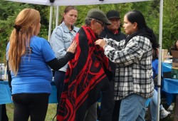 Cecil Sabbas is wrapped in a blanket at the gathering on Oct. 9. 