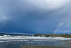 A rainbow shimmers at the northern end of Chesterman Beach or “n̓an̓aquuʔa” (pronounced nah-nah-kuu-ah), which means and means “needlefish”.
