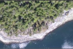 Satellite imagery of site EbSh-5 showing excavation trench locations and radiocarbon dates from immediately below the rock wall on northern Quadra Island. (Smith et al. photo)