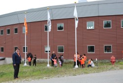 Children lower flags outside the Huu-ay-aht Government Office in Anacla on Sept. 30.