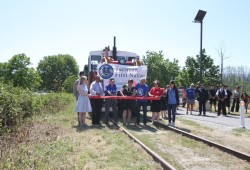 Representatives from the Island Corridor Foundation and the Alberni Pacific Railway cut a ribbon by the Barclay hotel on May 2, celebrating the train's expanded service to the location. 