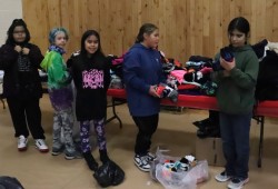 Haahuupayak students leave donated clothing by the athletic hall entrance.