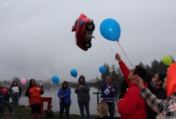 Patrick Lucas and family watch balloons float above the Victoria Quay in Port Alberni in March 2022 during a vigil for his late son. 