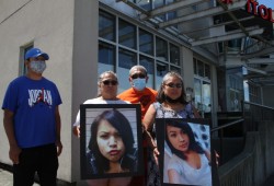 Family members Colin Frank (left), Mamie Lucas, Matthew Lucas and April Lucas stand outside Port Alberni’s Capital Theatre holding pictures of Jocelyn George on June 21, 2021 the first day of a coroners inquest into the circumstances surrounding her death after a night in police custody five years prior. (Eric Plummer photo)