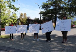 Family and supporters of Dontay-Patrick Lucas hold signs during a preliminary inquiry into the boy's death in June 2023.