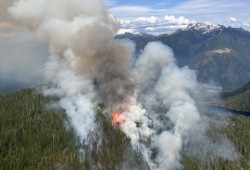 The Jacklah River wildfire, located approximately five kilometres south of Gold River, has changed status to “under control”, after growing to 35 hectares. (BC Wildfire Service photos)