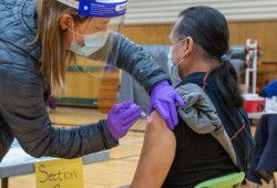 Ahousaht residents were among the first in B.C. to receive immunization for COVID-19 in early January 2021. Pictured is former chief councillor Greg Louie getting a shot at the Maaqtusiis school gym. (Courtenay Louie photo) 