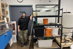 Hesquiaht member Jayden Corbeil poses beside his proof-of-concept aquaponics system he is manufacturing for the Haíɫzaqv Climate Action Team. (Submitted photo)