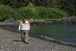 Jeneva Touchie looks for blue trade beads on ƛ̓issimyis (klis-sim-yis) beach, meaning white sand beach, in the Yuułuʔiłʔatḥ community of Hitacu. 