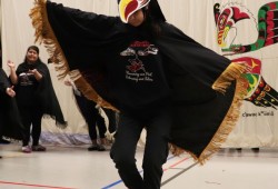 Shea Mark performs the eagle dance, composed by Daisy Hanson, Waakiitaam and Russel Hanson, and Russel Hanson, at a youth cultural sharing event hosted by the Kyuquot Elementary Secondary School.