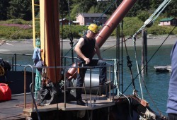 Sean Mather, owner and captain of Uchuck III operates the union purchase mainstay to offload supplies and equipment at Yuquot docks. 