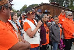 Tseshaht elder Randy Fred speaks with other former residential school students.