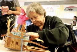 Tyaa Taylor finesses cedar bark into a basket.